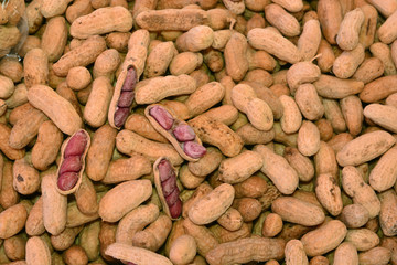 Peanuts in shell texture background. Raw peanuts on display at a  market