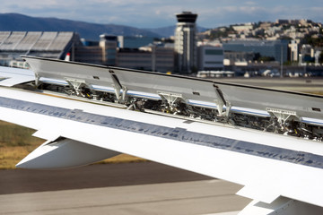 aircraft landing in airport wing flaps in action