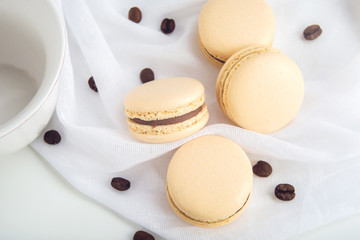 Coffee macarons with chocolate. French delicate dessert for Breakfast