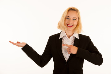 Attractive beautiful young blonde woman pointing into copyspace when advertising a product