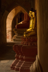 Statues of Buddha in the corridors of Sulamani Guphaya temple in the World Heritage Site of Bagan, Myanmar