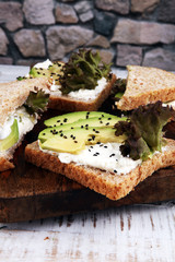 Sandwich with avocado and sesame - healthy breakfast concept