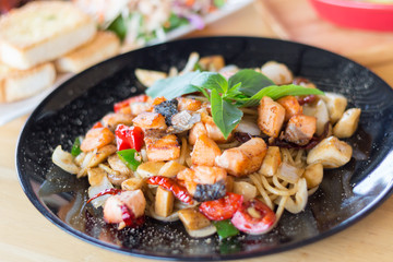 spicy herbal spaghetti with smoked salmon meat(selective focus)