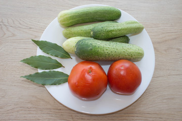 Organic vegetables on table. Include fresh organic vegetables and Cucumber on wooden floor. Green Cucumber. Summer frame with fresh organic vegetables on wooden background