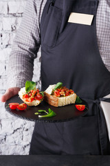 Waiter offering delicious restaurant dish