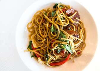spaghetti mix thai spicy style in white plate