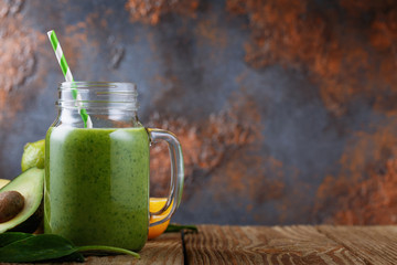 Smoothies of avocado, orange, lime and spinach leaves with space for text