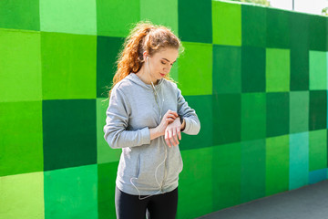 Young woman using smart watch, bright backgroud