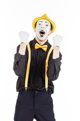 A happy young man, an actor, pantomime, rejoices in success.