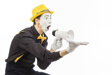 Portrait of a male mime artist, shouting or showing on a megaphone