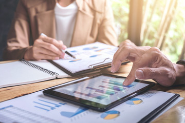 Fototapeta premium Co working conference, Business team meeting present, investor colleagues discussing new plan financial graph data on office table with laptop and digital tablet, Finance, accounting, investment
