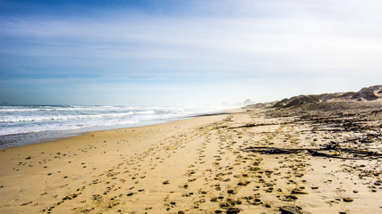 The beautiful beach and dunes of Bloubergstrand on the Atlantic side of the Western Cape just north of the city of Cape Town under blue sky