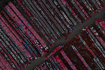 Warehouse containers in red on the street in the open air. Logistics center. Aerial view. From above