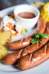 Sausage set with potato and salad.