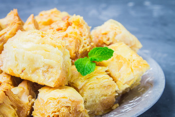 baklava turkish traditional delight on a dark wood background. toning