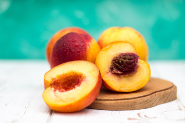 a lot of fresh peaches on a white table
