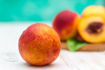 a lot of fresh peaches on a white table