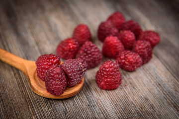 Fresh berries raspberry forest fruit on a wooden table 