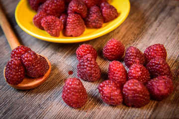 Fresh berries raspberry forest fruit on a wooden table 