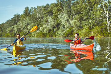 A canoe trip along the river along the forest in summer. © Bondariev Volodymyr.
