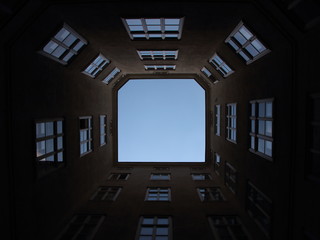 Fototapeta na wymiar Urban Backyard with Windows and Blue Sky Light Effect
