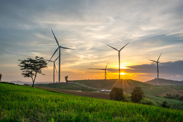 Wind generators turbines at sunset. Beautiful mountain landscape with wind generators turbines at...
