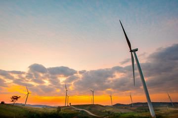Wind generators turbines at sunset. Beautiful mountain landscape with wind generators turbines at Khao Kho mountain, Thailand. Renewable energy concept.