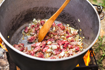Traditional cooking in the nature. Cauldron on fire