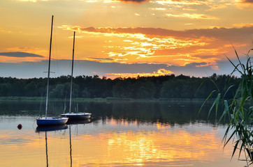 Boats on a beautiful lake. Evening summer landscape by the water.