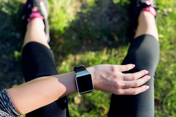 Close-up Shot. Sportive Woman After Workout Session Checking Fitness Results on Smart Watch. Top view shot of young woman checking fitness progress on her smart watch.