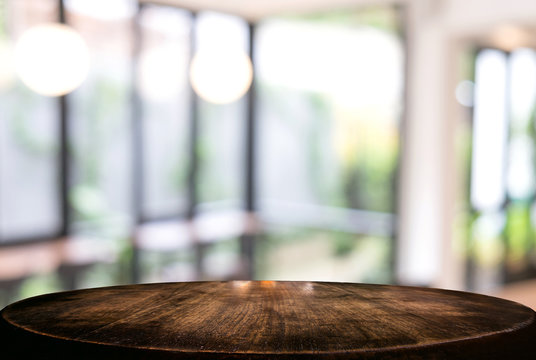 Image of Selected focus empty wooden table and Coffee shop or blurred cafe background of abstract with bokeh image. for montage or display your products