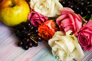 Roses, grapes and apples closeup