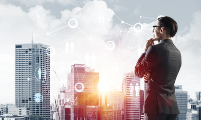 Concept of business success and control with confident boss against cityscape background