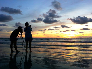 Mate take a photo view of sunset at sea with twilight light.