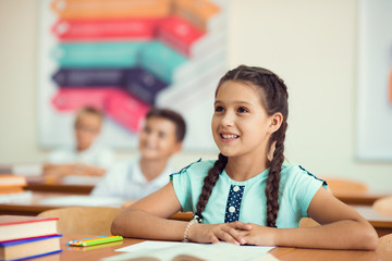 Happy clever children learning in classroom