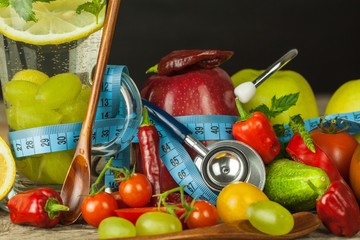 Glasses of water and a tailor's meter. Fruits and vegetables. The concept of weight loss. Healthy...