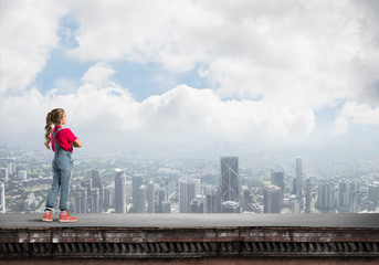 Naklejka premium Concept of careless happy childhood with girl looking far away