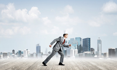 King businessman in elegant suit running and modern cityscape at background