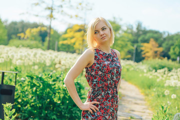 Fototapeta premium Portrait of a young beautiful smiling blonde at outdoor in the park