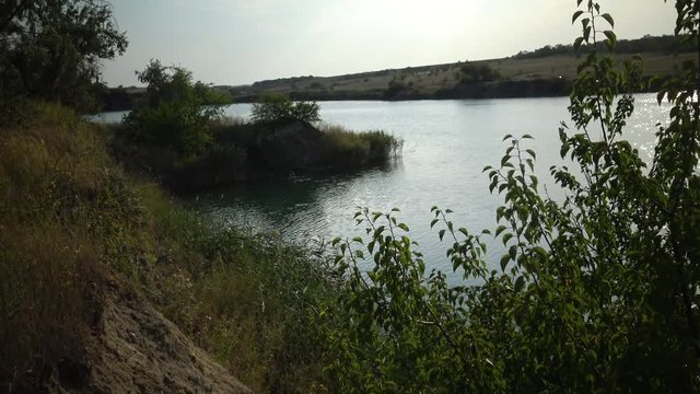 Flooded granite quarry. Freshwater lake. Beautiful nature around