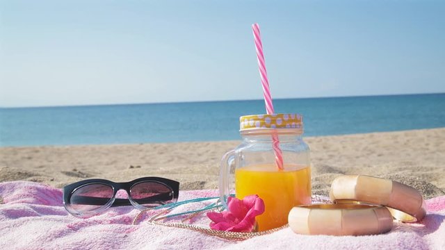 Summer time with juice and sea / ocean on the beach.
