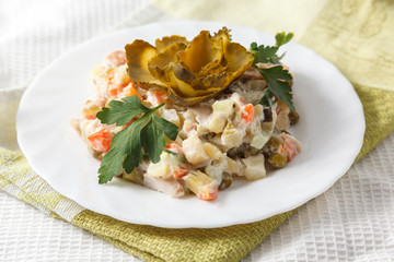 Russian salad Olivier on a white plate
