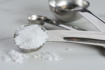 Sea Salt Flakes Spilled from a Teaspoon