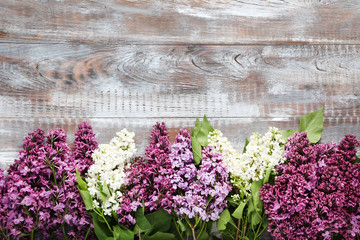Branch of lilac flowers on wooden table