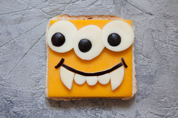 Funny monster sandwich for kids lunch on a table. Halloween food