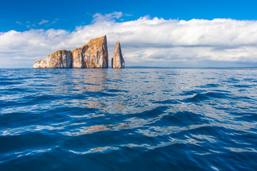Rocks stick out of the water .. Pacific Ocean. Ecuador. The Galapagos Islands. Isla San Cristobal...