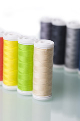 Sewing equipment and  threads on white background.