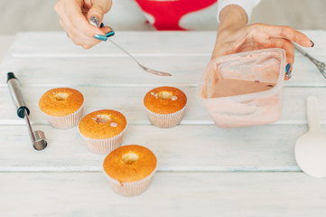 Young girl makes delicious tender cupcakes.