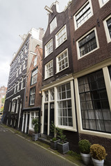 Fototapeta na wymiar Traditional dutch narrow tall houses with contrasting window frames