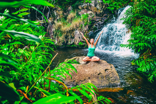 Yoga Nature Wellness Meditation Retreat Woman At Tropical Waterfall Forest In Kauai, Hawaii. Happy Girl With Open Arms In Serenity Enjoying Lush Outdoors, Mindfulness Concept.